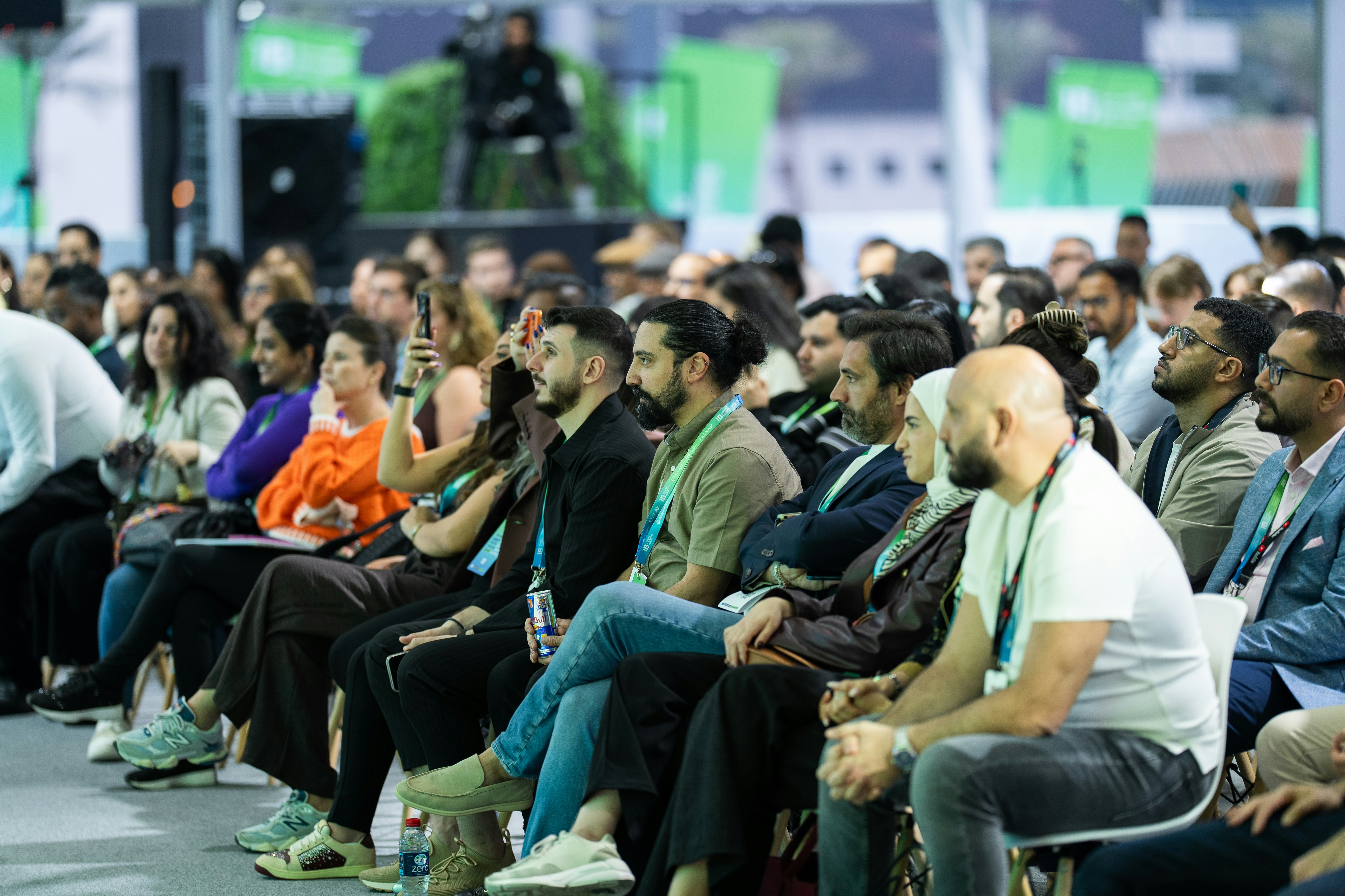 A conference audience looking at a panel on stage